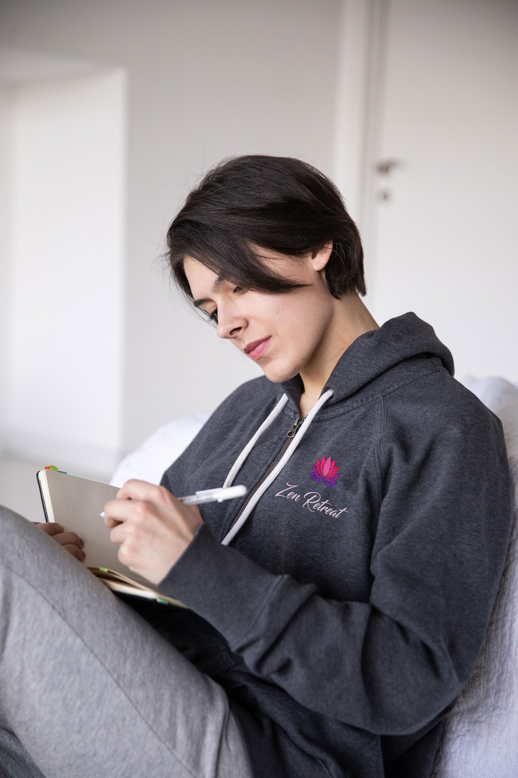 Woman reading a book in a custom imprinted hoodie